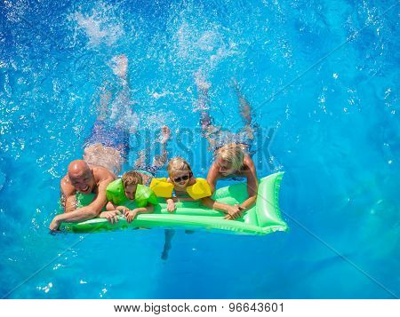 Family Outside Relaxing In Swimming Pool on a lilo