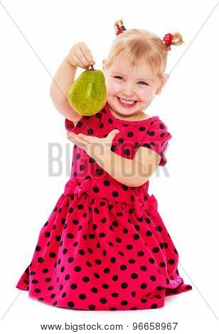 Little girl holding a pear