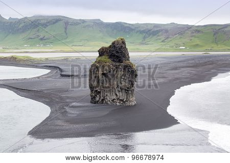 The Black Sand Beach With Typical Icelandic Mountain Landscapes