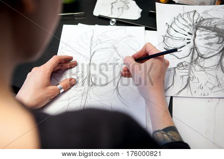Girl Tattoo Artist Draws A Sketch. Close-up Of Hands