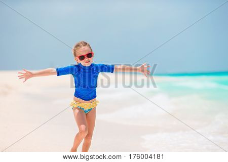 Adorable little girl at beach during summer vacation
