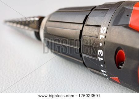 Screwdriver closeup with a stepped drill bit