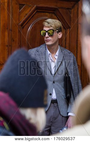 MILAN ITALY - FEBRUARY 25: Fashionable man poses outside Blumarine fashion show during Milan Women's Fashion Week on FEBRUARY 25 2017 in Milan.