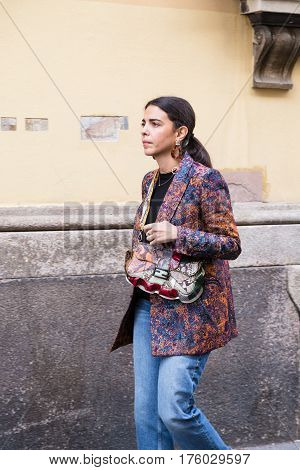 MILAN ITALY - FEBRUARY 25: Fashionable woman poses outside Blumarine fashion show during Milan Women's Fashion Week on FEBRUARY 25 2017 in Milan.