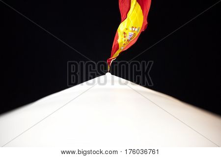 Spanish flag in the Colon square of Madrid at night. Picture taken from the mast