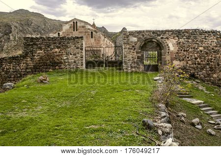 Gate and the front door in the cyclopean wall built around medieval monastery Tsitsernavank