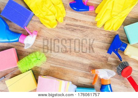 Spring cleaning concept - colorful sprays botles and rubbers frame