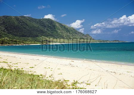 Sandy beach and turquoise green sea in front of cape in Ishigaki island
