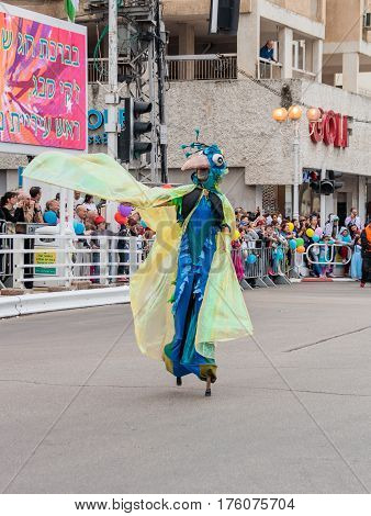 Participants At сarnival On Stilts Are Walking Along The Street