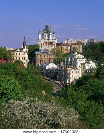 Andriyivskyy Descent and the Saint Andrew's Church with blossom trees in foreground. Kiev.