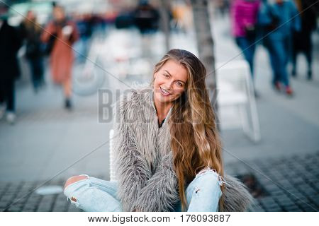 Stylish happy girl in the coat and glasses