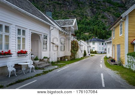 Solvorn town retro style wooden houses and empty narrow street. Lustafjorden, Norway.