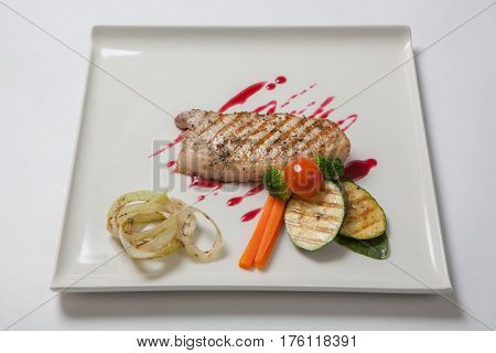 Pork Medium Rare With A Side Dish Of Grilled Zucchini Flavored Cranberry Sauce