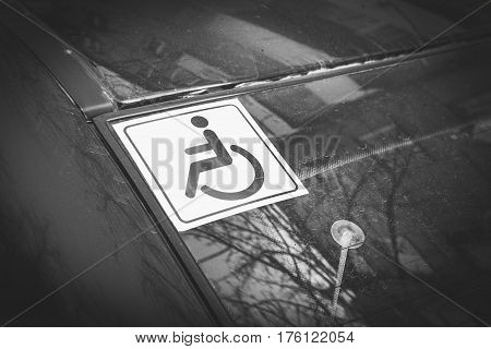 Disabled sign on the car glass. Macro shot.