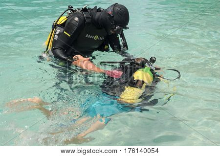 Child Discover Scuba Diving At Cala Mariolu Beach On Sardinia