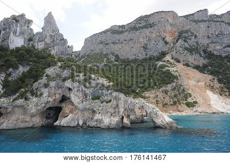 Cala Goloritze, Italy - 28 June 2013: people swimming and sunbathing at Cala Goloritze beach on Sardinia, Italy