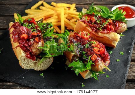 Cumberland sausage hot dogs with caramelized onion, roasted red peppers, french fries