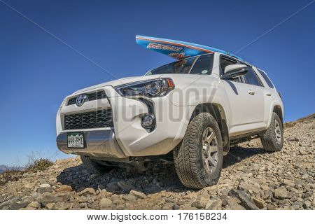LEADVILLE, CO, USA - SEPTEMBER 27, 2016: Toyota 4Runner SUV (2016 Trail edition) with a paddleboard descending  from the Mosquito Pass on a rocky jeep trail in Colorado's Rocky Mountains