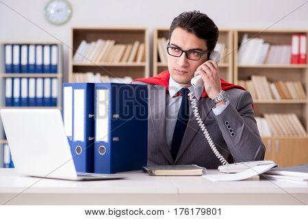 Superhero businessman working in the office