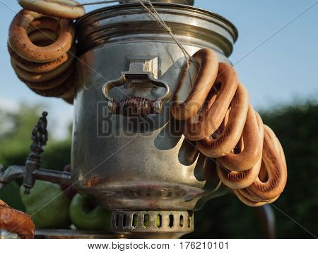 A Samovar With A Bunch Of Bagels Hanging On It