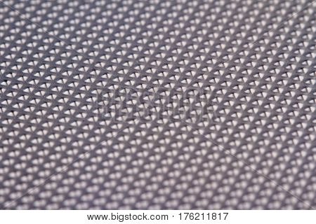 horizontal detail of industrial aluminum metal silver background texture with embossed bumps and selective focus