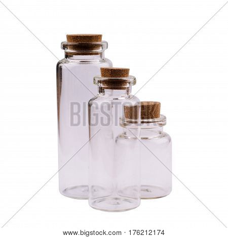 front view of empty small glass jars in three sizes and shapes with brown corks isolated on white background