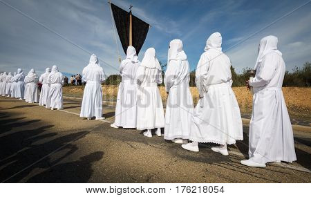 Tourist shadows enjoying easter traditional procession in bercianos de aliste brotherhood, zamora, Spain