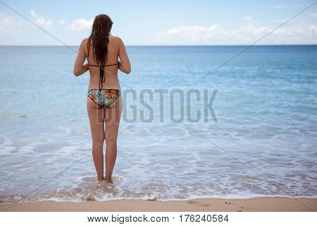 A young girl is going to swim in the ocean. sea paradise summer vacation