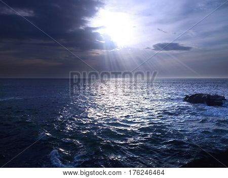 Cold, blue and calm sea under a cloudy sky