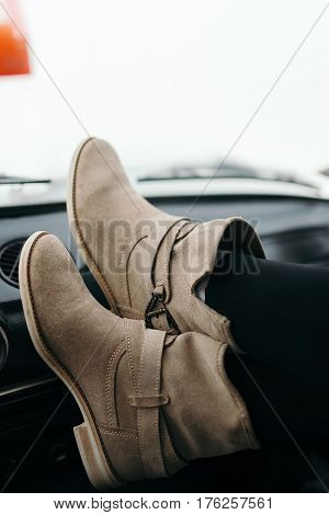 Freedom car travel concept - woman relaxing with feet on dashboard. Sexy woman in the car.