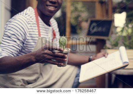 Adult Man Checking Plants Outside Flower Shop