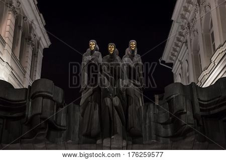 Vilnius Lithuania - january 08 2017: Vilnius Lithuania. Statues of Three Muses on Lithuanian National Drama Theatre at night. National Drama Theatre in Vilnius on Gediminas Avenue. Main entrance. Dramatic night background sets the mood.