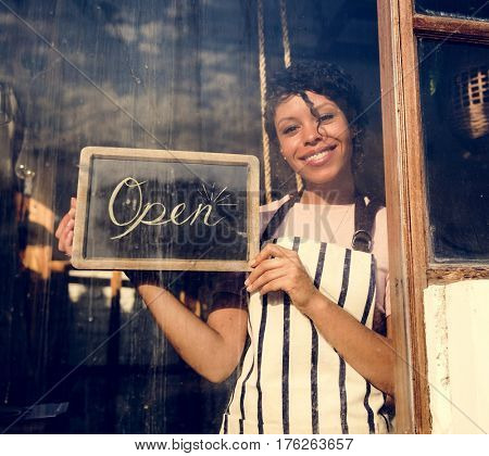 Woman Hanging Open Sign by the Glass Window