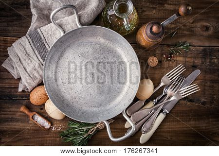 Ingredients for cooking and and empty pan, eggs and spices. Food background concept with copyspace.