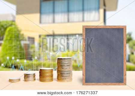 Business finance and real estate concepts Money coin stack with growing graph Chalkboard free space for you planing Blurred home garden background.
