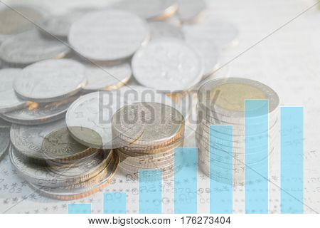 Double exposure of money coins stack with growing graph for finance and banking concept.