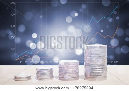 Double exposure of money coins stack with growing graph and abstract bokeh background for finance and banking concept.