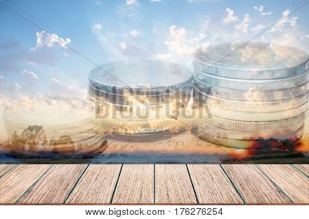 Double exposure of money coins for finance and banking concept Empty wood table top perspective wood can be used for display products.
