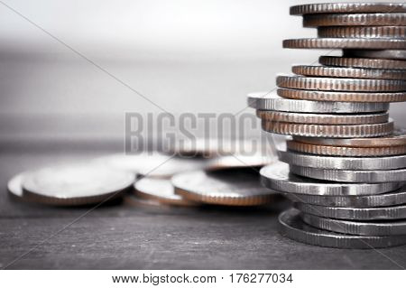 Coins stacked on each other in different positions Finance and business concept Selected focus Abstract background. (Macro with blur and soft focus low light)