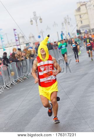 BRIGHTON GREAT BRITAIN - FEB 26 2017: Man dressed as a banana and competitors r running in the Vitality Brighton half marathon competition. February 26 2017 in Brighton Great Britain