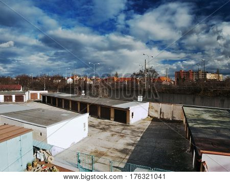 Chomutov Ustecky kraj Czech republic - March 06 2017: white clouds and dark blue sky over garages and road number 13