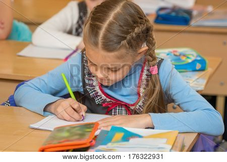 First-grader At A Lesson Of Mathematics To Solve The Examples Notebook