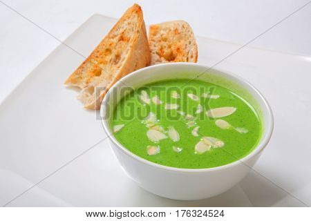 Asparagus Cream Soup In White Bowl With Bread