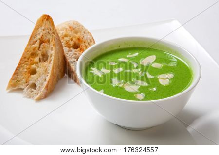 Asparagus Cream Soup In White Bowl With Bread