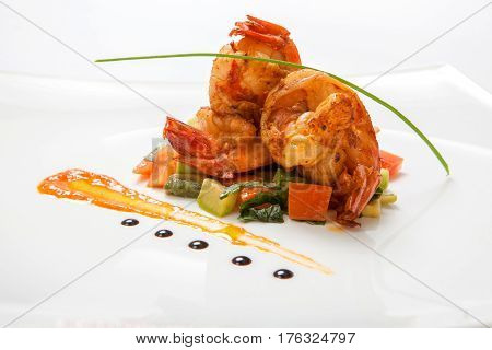 Fried Shrimps On Fried Vegetables On A White Plate