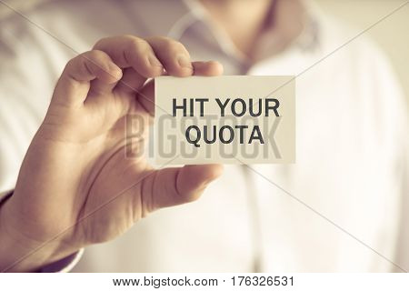 Businessman Holding Hit Your Quota Message Card