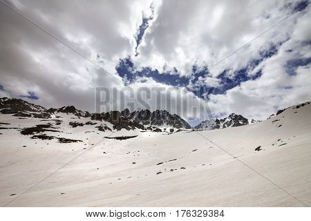Snow mountain and cloud sky in gray spring day. Turkey Kachkar Mountains highest part of Pontic Mountains. Wide angle view.