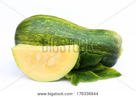 Whole zucchini and a slice isolated on white