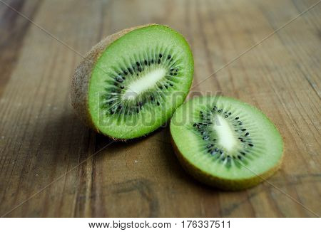 Kiwi greencolor fruit on brown wooden background