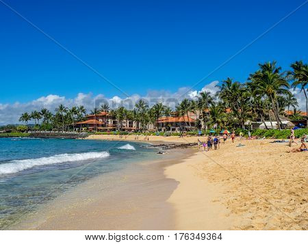 KAUAI, USA - MAR 3: Tourists and locals enjoy Poipu Beach on March 3, 2017 on Kauai, Hawaii. Poipu Beach is one of the most popular tourist areas on the island of Kauai and has many excellent hotels.